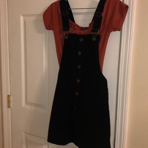 Black overalls and a maroon shirt